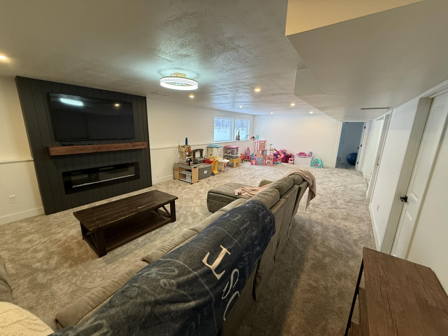 Finished basement living room with fireplace