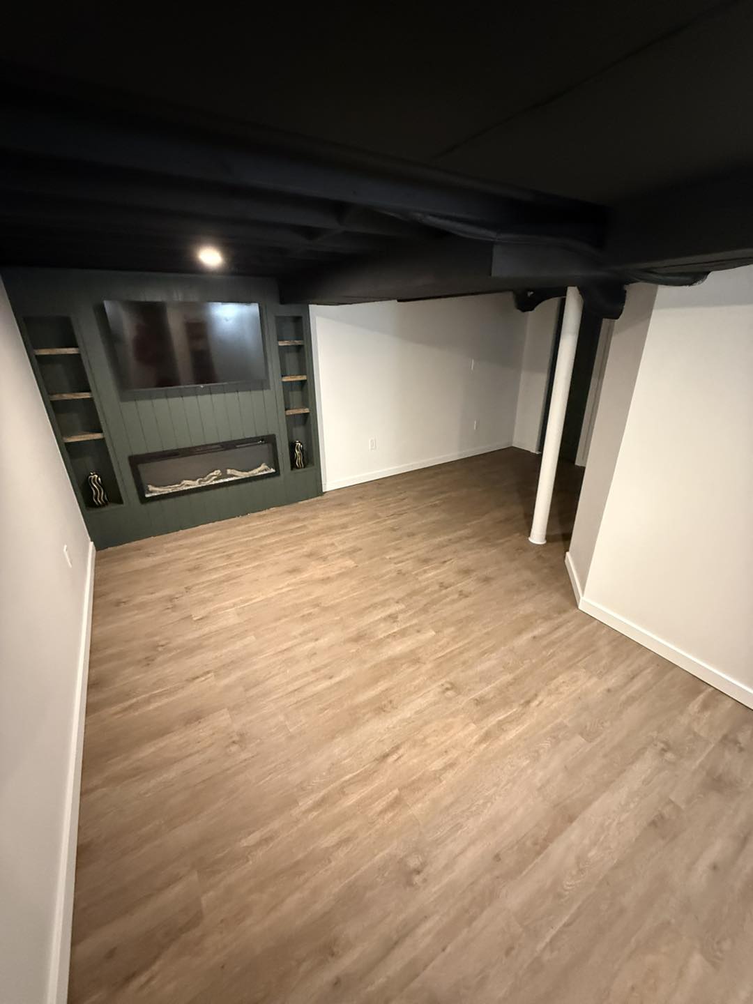 Basement finishing with dark exposed ceiling